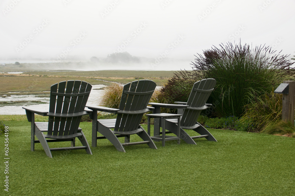 Fototapeta premium Adirondack chairs positioned to enjoy the bird sanctuary