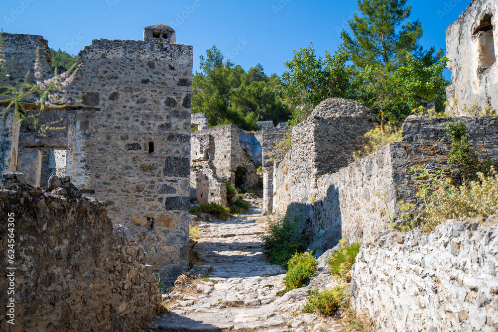 Stone street and Greek house ruins in the ghost town Kayakoy. Kayakoy is abandoned Greek village in Fethiye district, Turkey.