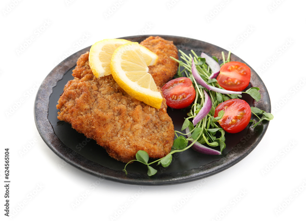 Plate of delicious schnitzels with lemon, tomatoes, onion and microgreens isolated on white Plate of delicious schnitzels with lemon, tomatoes, onion and microgreens isolated on white