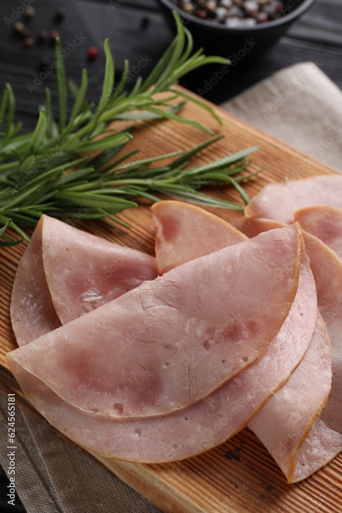 Slices of delicious ham with rosemary on table, closeup Slices of delicious ham with rosemary on table, closeup