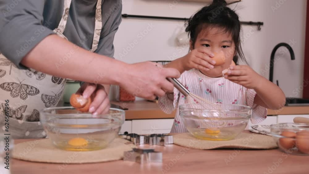 Pregnant woman preparing food with her little daughter Pregnant woman preparing food with her little daughter