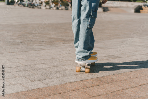 Teenage boy riding on skateboard on the street, copy space 