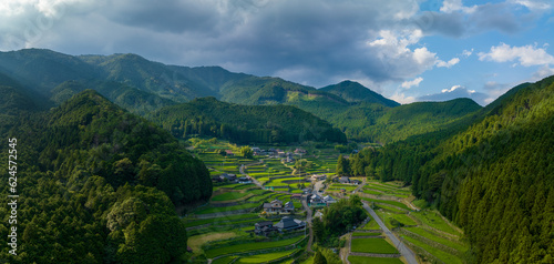 Terraced rice fields of traditional farming village in green mountains Fototapet
