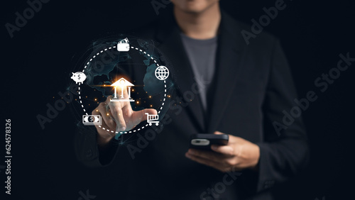 Businessman pointing to a hologram online banking icon set, representing finance, technology, and secure digital banking services. Business and financial concept photo