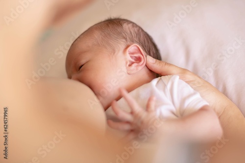 A mother nursing her newborn child. Babies breastfeeding.
