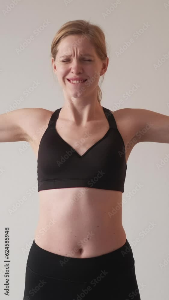 Vertical video. Exhausting training. Sport motivation. Strength endurance. Tired athletic woman performing hard exercise with dumbbells. Vertical video. Exhausting training. Sport motivation. Strength endurance. Tired athletic woman performing hard exercise with dumbbells.