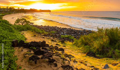 Sunrise on The Rocky Shoreline of Shipwreck Beach, Kauai, Hawaii, USA photo