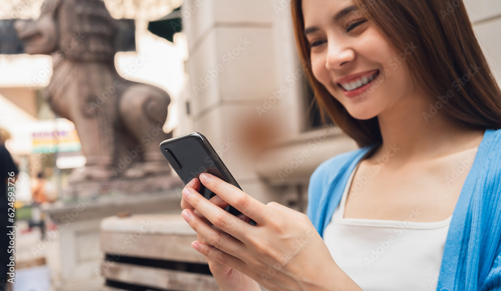 woman using smartphone in public areas, During leisure time. The concept of using the phone is essential in everyday life. woman using smartphone in public areas, During leisure time. The concept of using the phone is essential in everyday life.