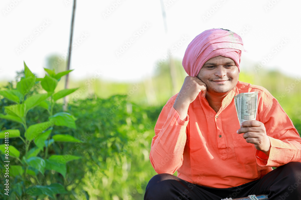 Happy Indian farmer, farmer holding indian rupees in hands, smart farming Happy Indian farmer, farmer holding indian rupees in hands, smart farming