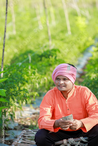 Happy Indian farmer, farmer holding indian rupees in hands, smart farming