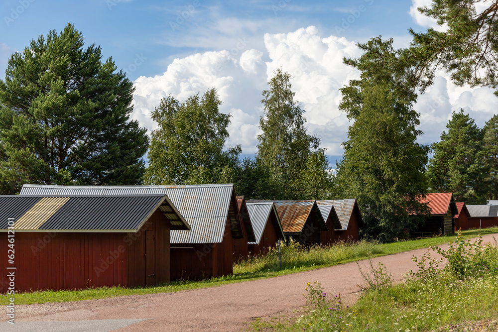 Obraz premium Nusnas, Sweden Small red boat houses on the shore of Lake Siljan.