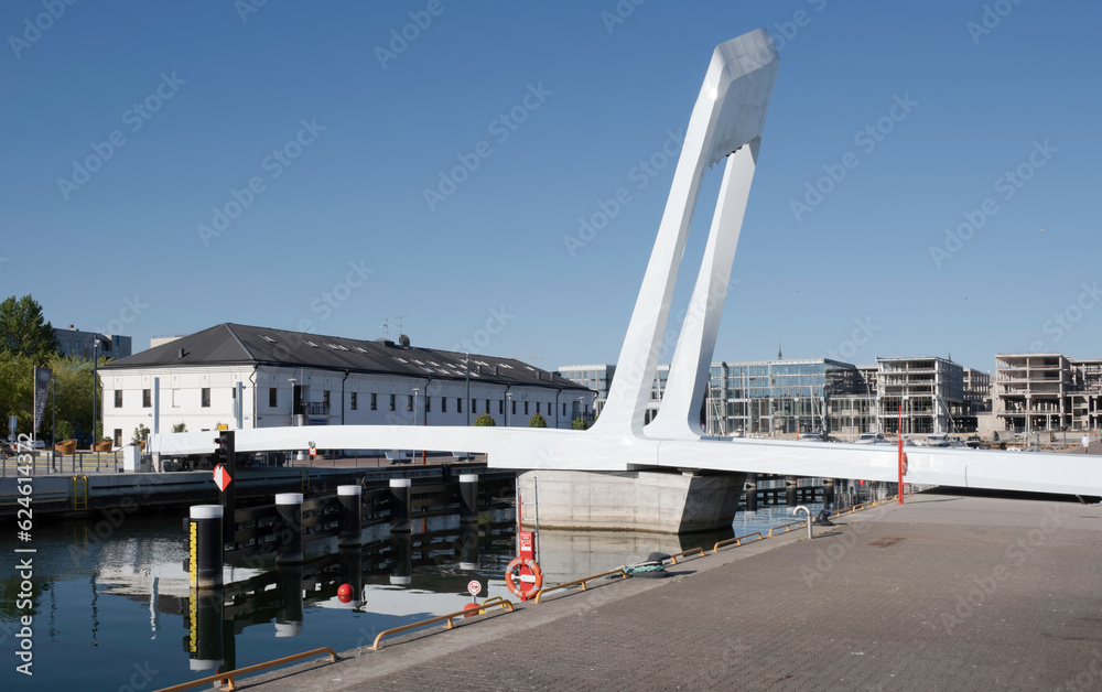 Fototapeta premium Estonia's dynamic, movable Admiral pedestrian bridge made with steel and durable composite, in Old City Harbor in the Port of Tallinn