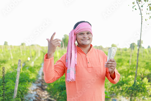 Happy Indian farmer, farmer holding indian rupees in hands, smart farming