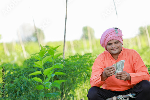 Happy Indian farmer, farmer holding indian rupees in hands, smart farming