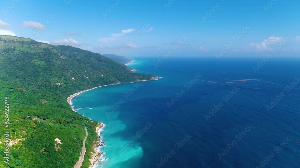 Drone view of the rocky coast, the crystal clear waters of the Caribbean Sea and the wildlife of the Dominican Republic. High mountains of the seaside. Scenic landscape of Central America wildlife. Drone view of the rocky coast, the crystal clear waters of the Caribbean Sea and the wildlife of the Dominican Republic. High mountains of the seaside. Scenic landscape of Central America wildlife.