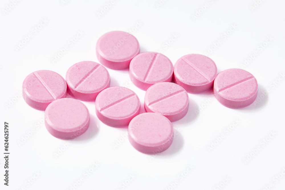 Top view of Many Circle-shaped pink pills isolated on a white background. Top view of Many Circle-shaped pink pills isolated on a white background.