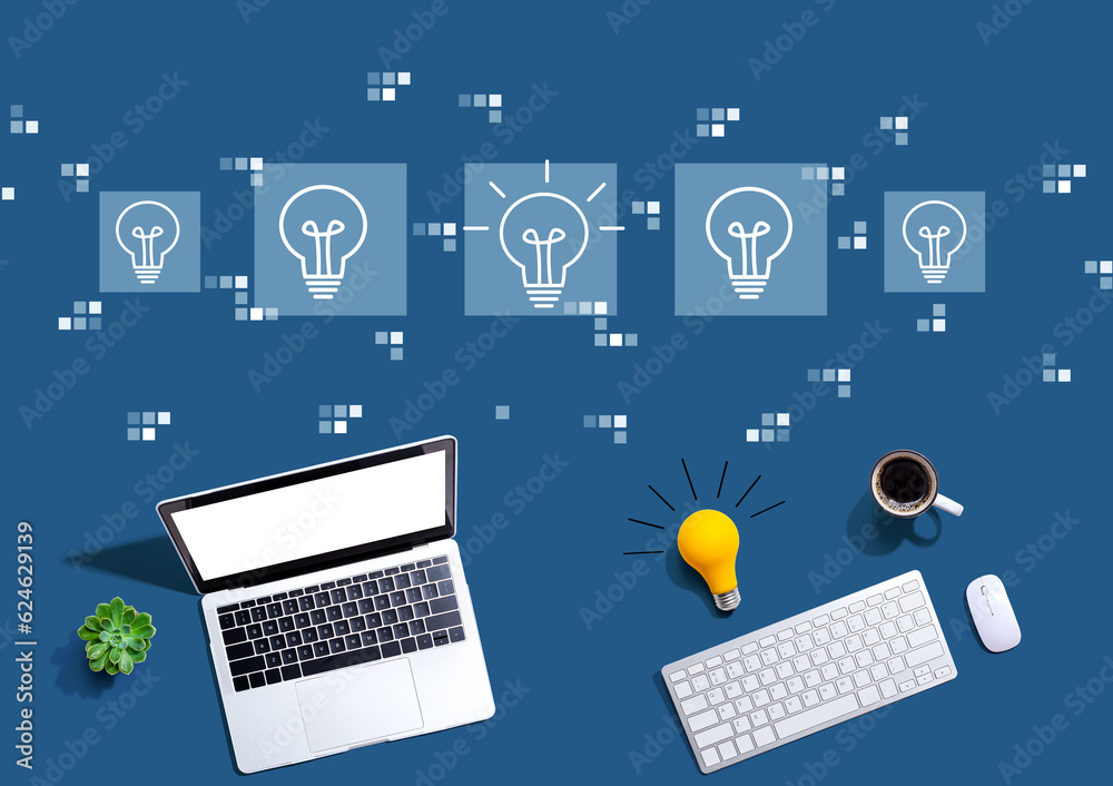 Idea light bulb theme with computers with a light bulb from above Idea light bulb theme with computers with a light bulb from above