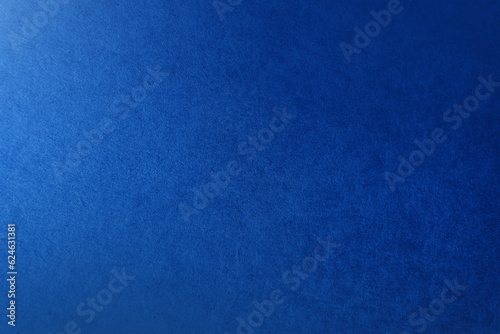 Rough texture of classic solid navy blue tone color paint on environmental friendly cardboard box blank paper texture background with space and minimal design grunge style