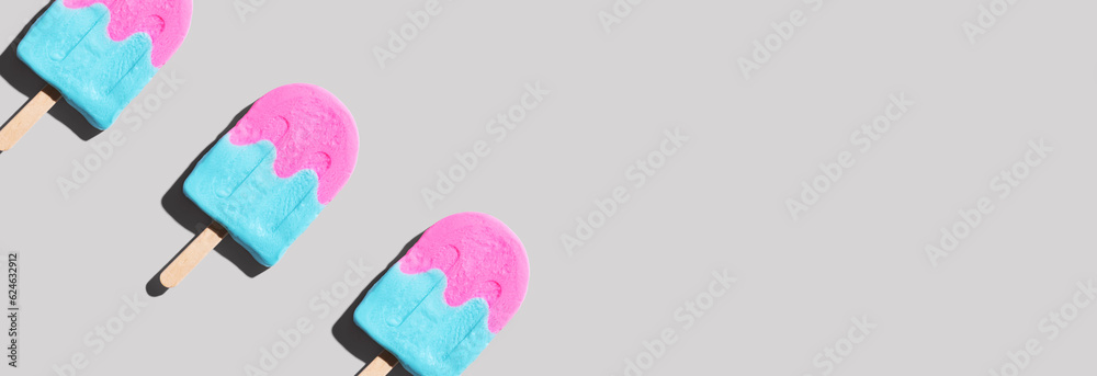 Pink and blue popsicles with shadow - flat lay Pink and blue popsicles with shadow - flat lay