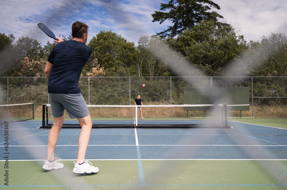 Two People Playing Pickleball on a Sunny Day Two People Playing Pickleball on a Sunny Day