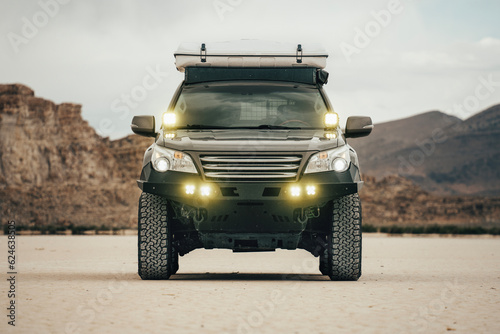 Offroad Vehicle On Salt Flat With Lights On