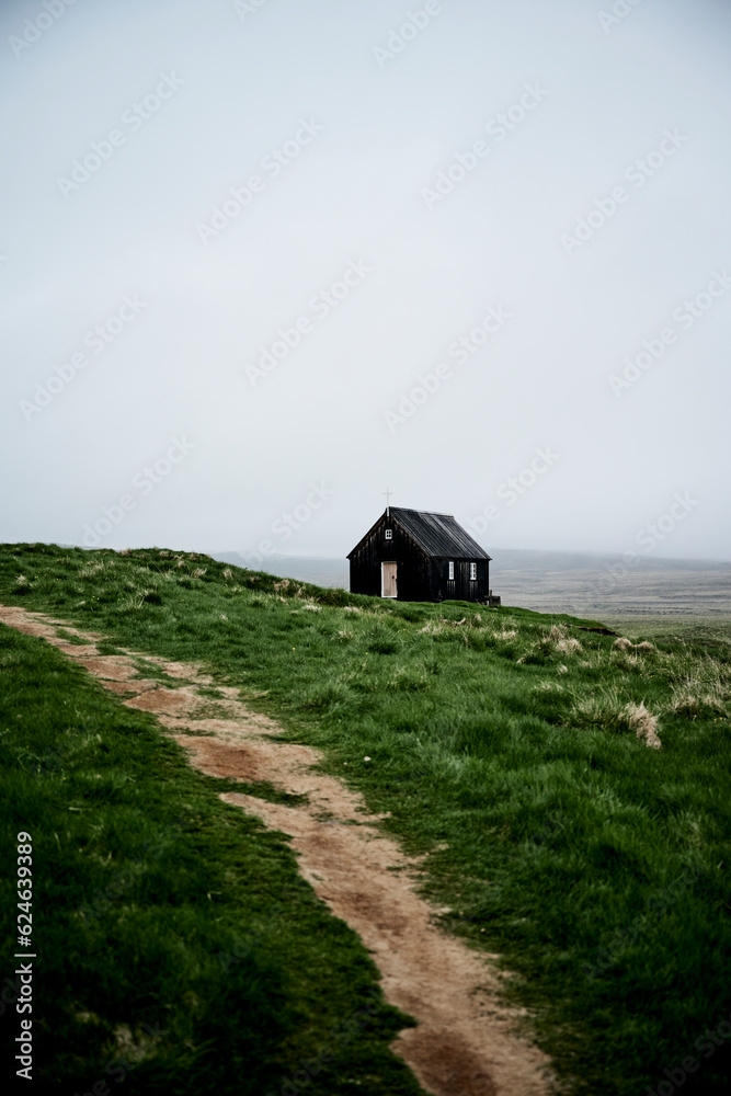 Rural path going through old church on grassy hill Rural path going through old church on grassy hill