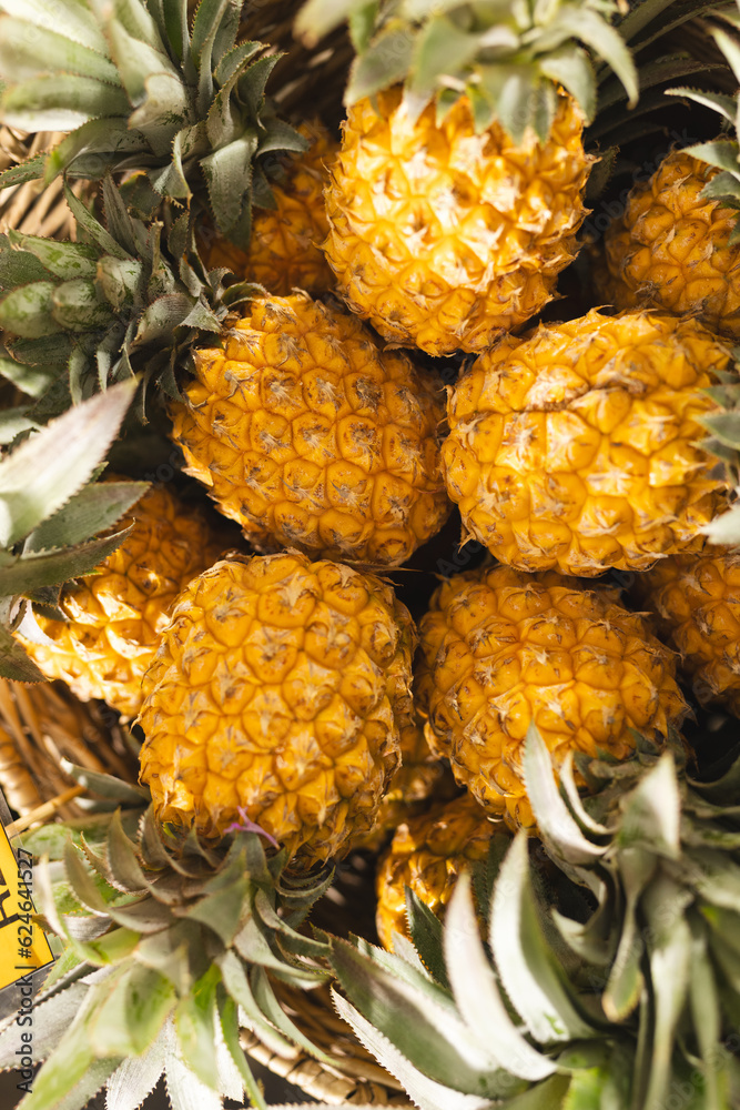 Close up of pineapples in box at health food organic grocery shop Close up of pineapples in box at health food organic grocery shop