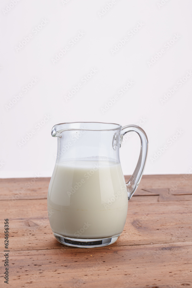 jug of milk on wooden rustic table jug of milk on wooden rustic table