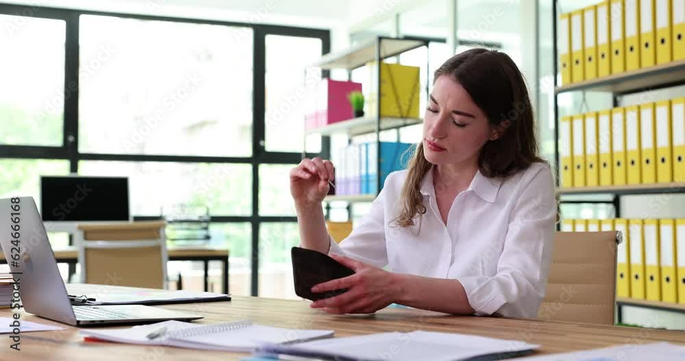Office worker checks empty wallet before payday and finds coin. Desperate lady drops head on hands. Small salary. Poverty. Inability to manage money Office worker checks empty wallet before payday and finds coin. Desperate lady drops head on hands. Small salary. Poverty. Inability to manage money