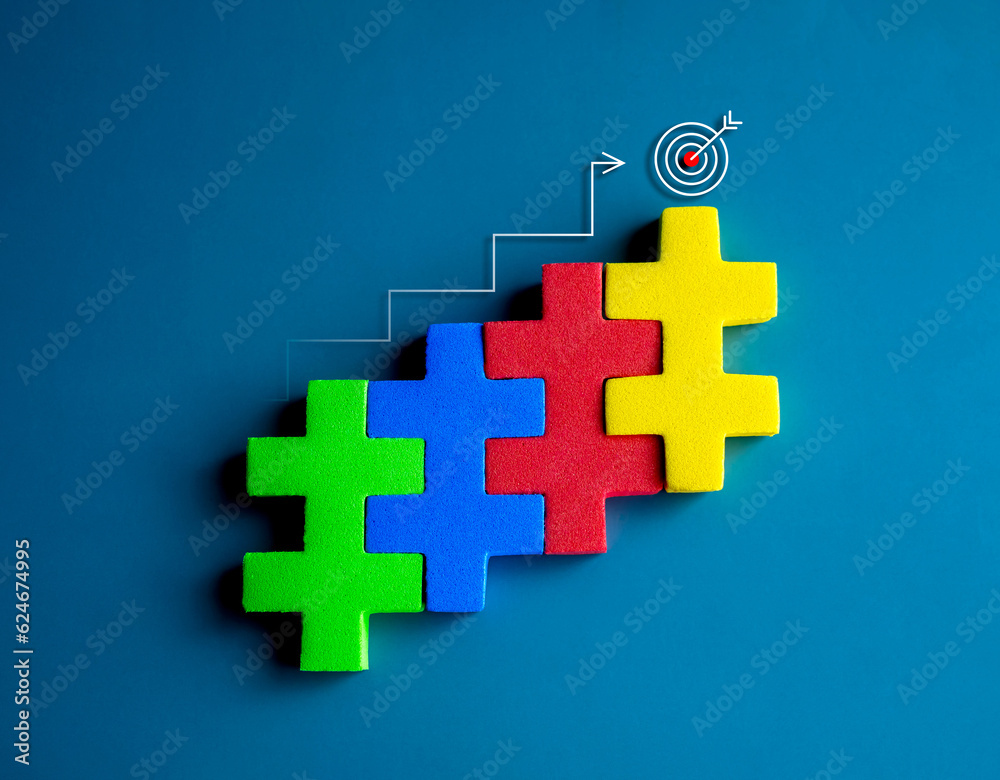 Obraz premium Target icon on top of colorful puzzle blocks bar graph chart steps with step up arrows on blue background, minimal style. Business growth process, profit, investment, economic improvement concepts.