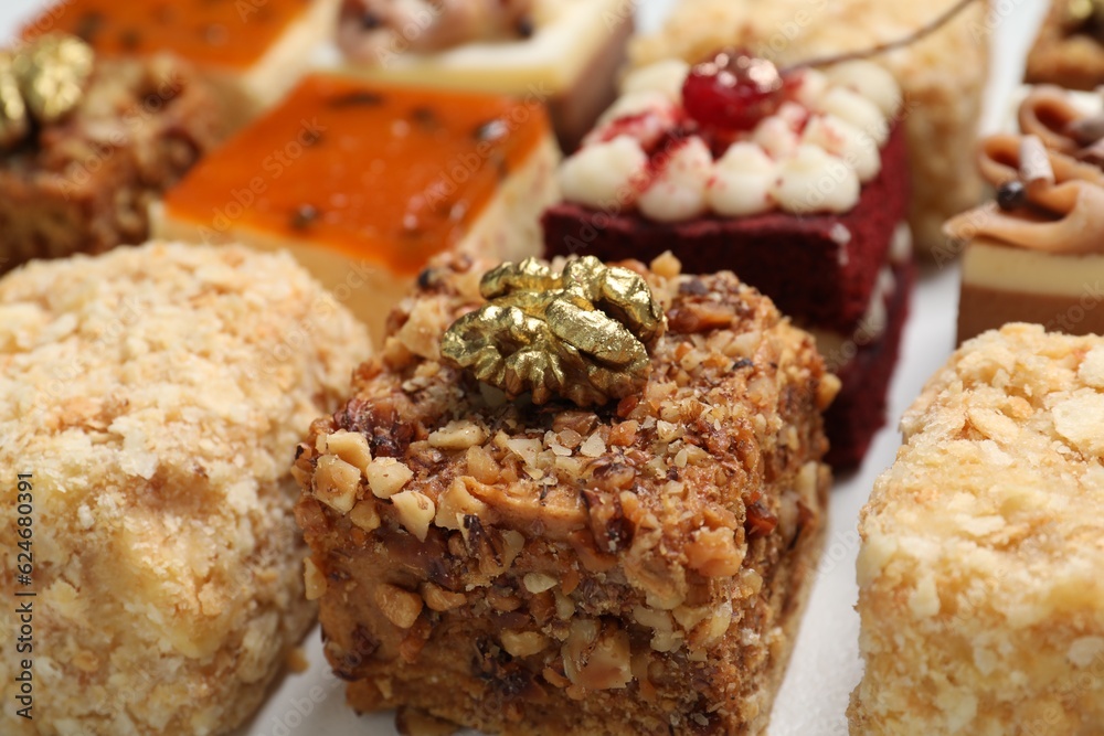 Pieces of different delicious cakes on table, closeup Pieces of different delicious cakes on table, closeup