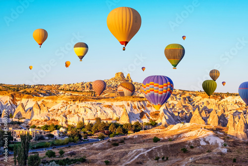 Colorful hot air balloons over Cappadocia, Turkey at sunrise sunset time. Amazing view on historical valley and ancient city Goreme