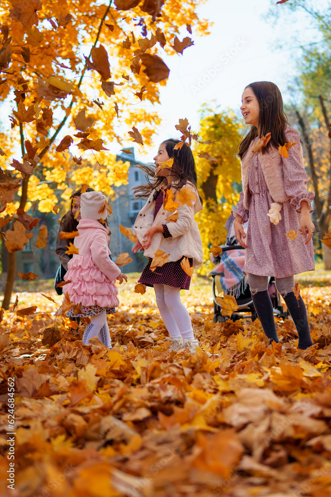 portrait of a big family in autumn city park, happy children and parents playing together and throwing yellow leaves, beautiful nature, bright sunny day portrait of a big family in autumn city park, happy children and parents playing together and throwing yellow leaves, beautiful nature, bright sunny day
