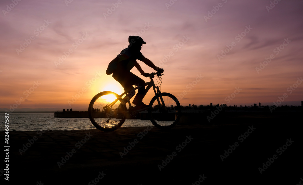 Silhouette of cyclist biking at the sunset Silhouette of cyclist biking at the sunset
