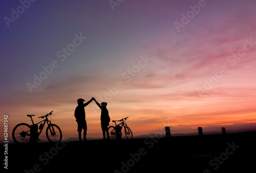 Silhouette of cyclist stop watching the sunset
