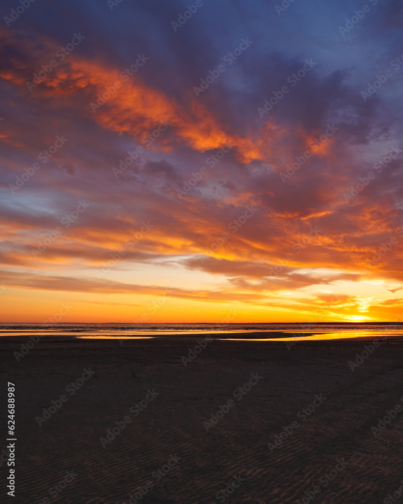 sunset sky with reflections in water, sunlight and colored orange clouds. Magnificent view of the sea and sun in evening. travel and freedom, meditation, poster. amazing sunset light on ocean sunset sky with reflections in water, sunlight and colored orange clouds. Magnificent view of the sea and sun in evening. travel and freedom, meditation, poster. amazing sunset light on ocean