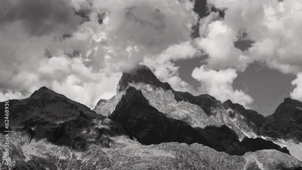 The Olan peak close-up in the Ecrins National Park with passing clouds (time-lapse in Black & White). Major peak of the GR54 Ecrins Massif hiking tour. Valgaudemar Valley, Hautes-Alpes, Alps, France