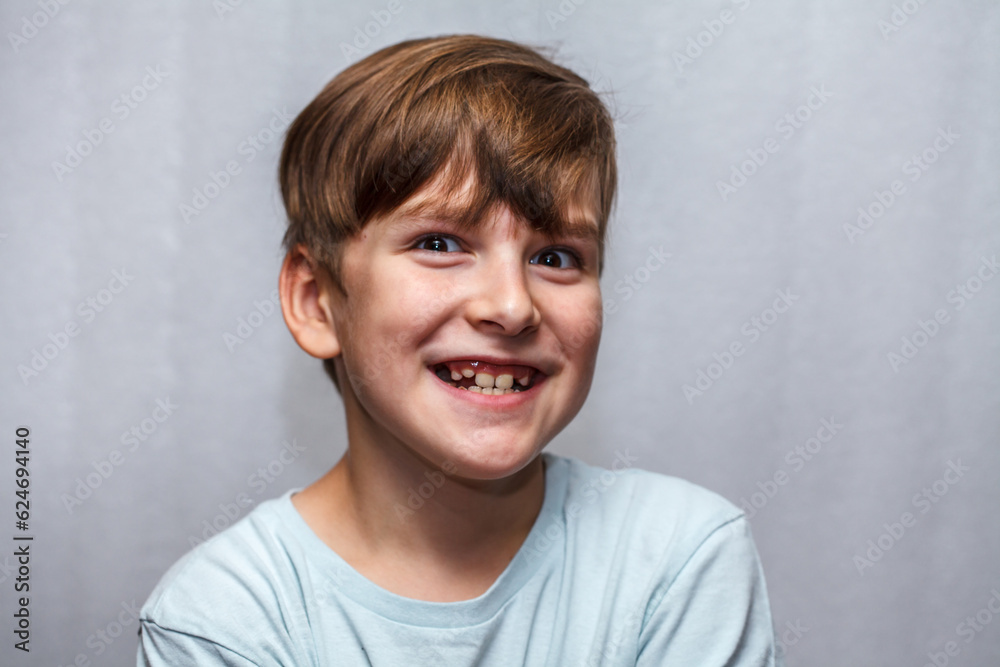 a nine-year-old boy makes faces at the camera. close-up portrait a nine-year-old boy makes faces at the camera. close-up portrait
