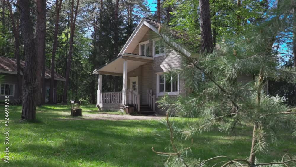 Classic country house in the Norwegian style of wood in the forest in the summer in the pines Classic country house in the Norwegian style of wood in the forest in the summer in the pines
