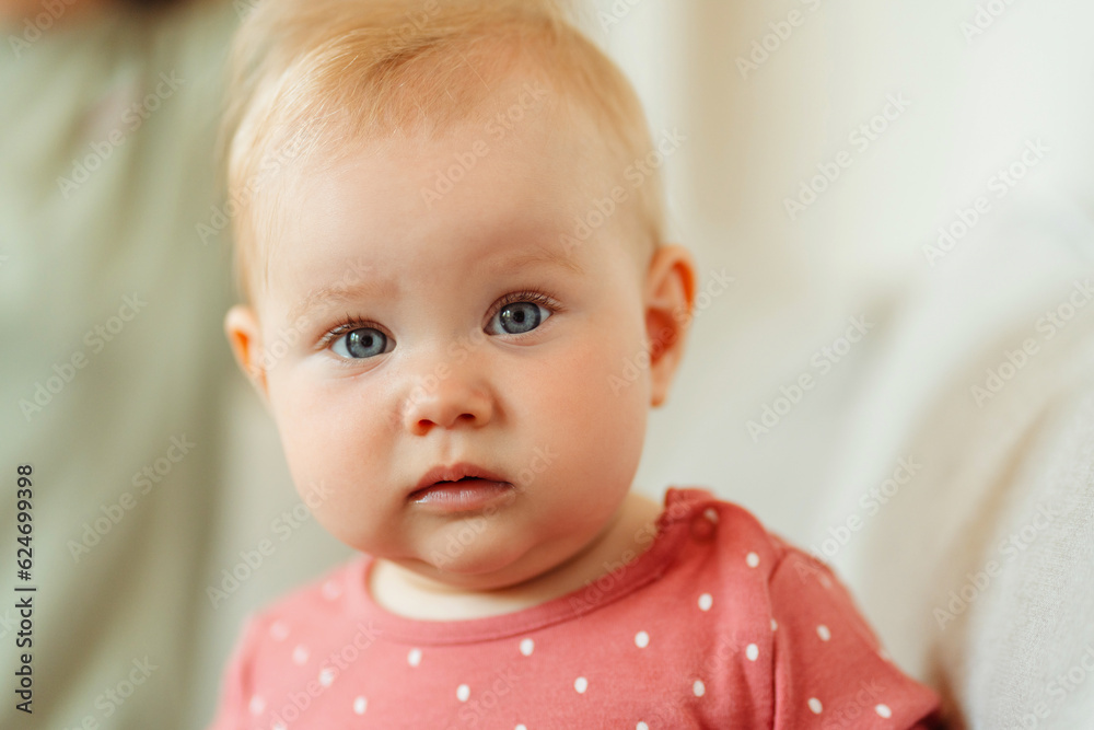 Portrait of cute little baby, toddler wearing stylish baby clothes looking at camera