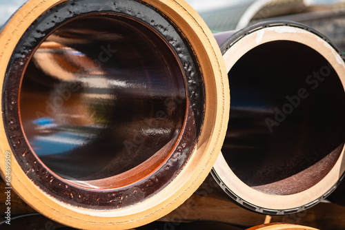 a stack of sewer pipes on a construction site