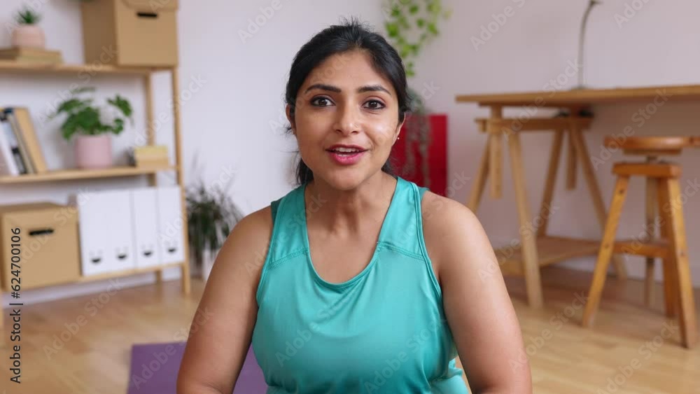 POV of young indian yoga female instructor teaching breathing and meditation online exercise through laptop video call from home studio. Online training sport class and fitness concept. Point of view POV of young indian yoga female instructor teaching breathing and meditation online exercise through laptop video call from home studio. Online training sport class and fitness concept. Point of view