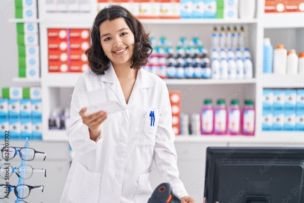 Young woman pharmacist holding prescription working at pharmacy Young woman pharmacist holding prescription working at pharmacy