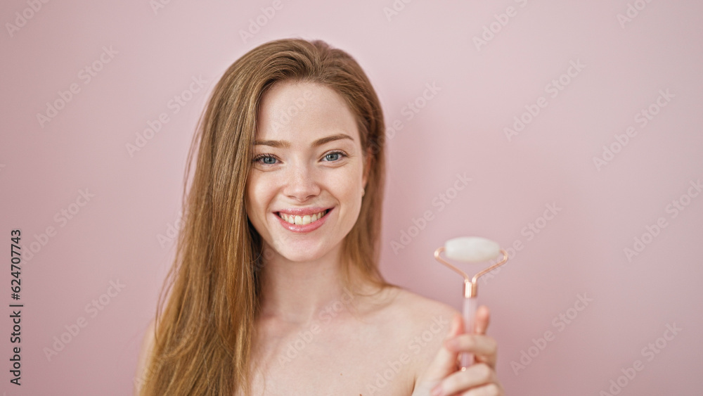 Young blonde woman holding skin gym smiling over isolated pink background Young blonde woman holding skin gym smiling over isolated pink background