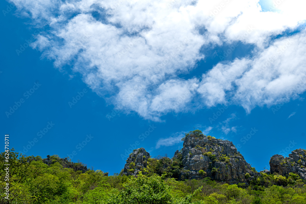 the stone mountain on blue sky background, Grey Stone mountain view on the sky background, Stone hill, Small hill on the blue sky background. the stone mountain on blue sky background, Grey Stone mountain view on the sky background, Stone hill, Small hill on the blue sky background.