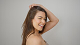 Young beautiful hispanic woman combing hair with hands winking eye over isolated white background