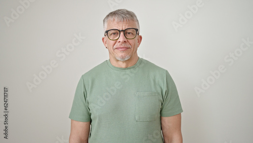 Middle age grey-haired man wearing glasses standing over isolated white background