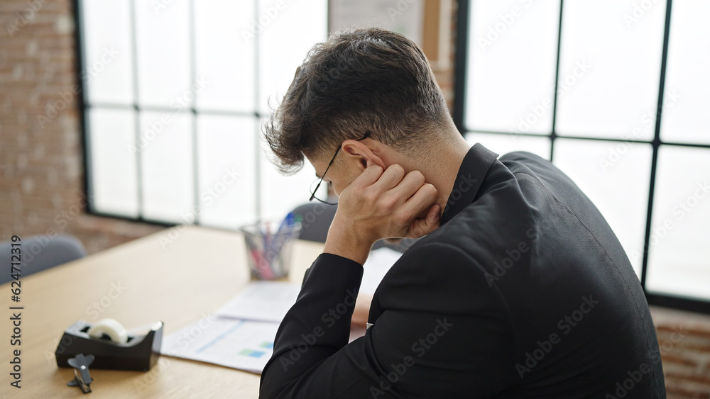 Young arab man business worker suffering for neck pain working at office Young arab man business worker suffering for neck pain working at office