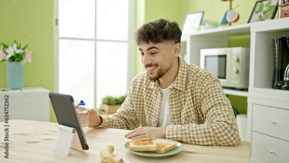 Young arab man having video call eating at home Young arab man having video call eating at home