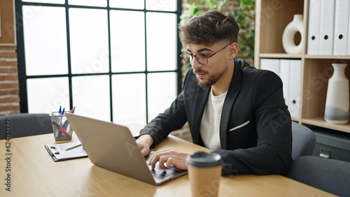 Young arab man business worker using laptop working at office